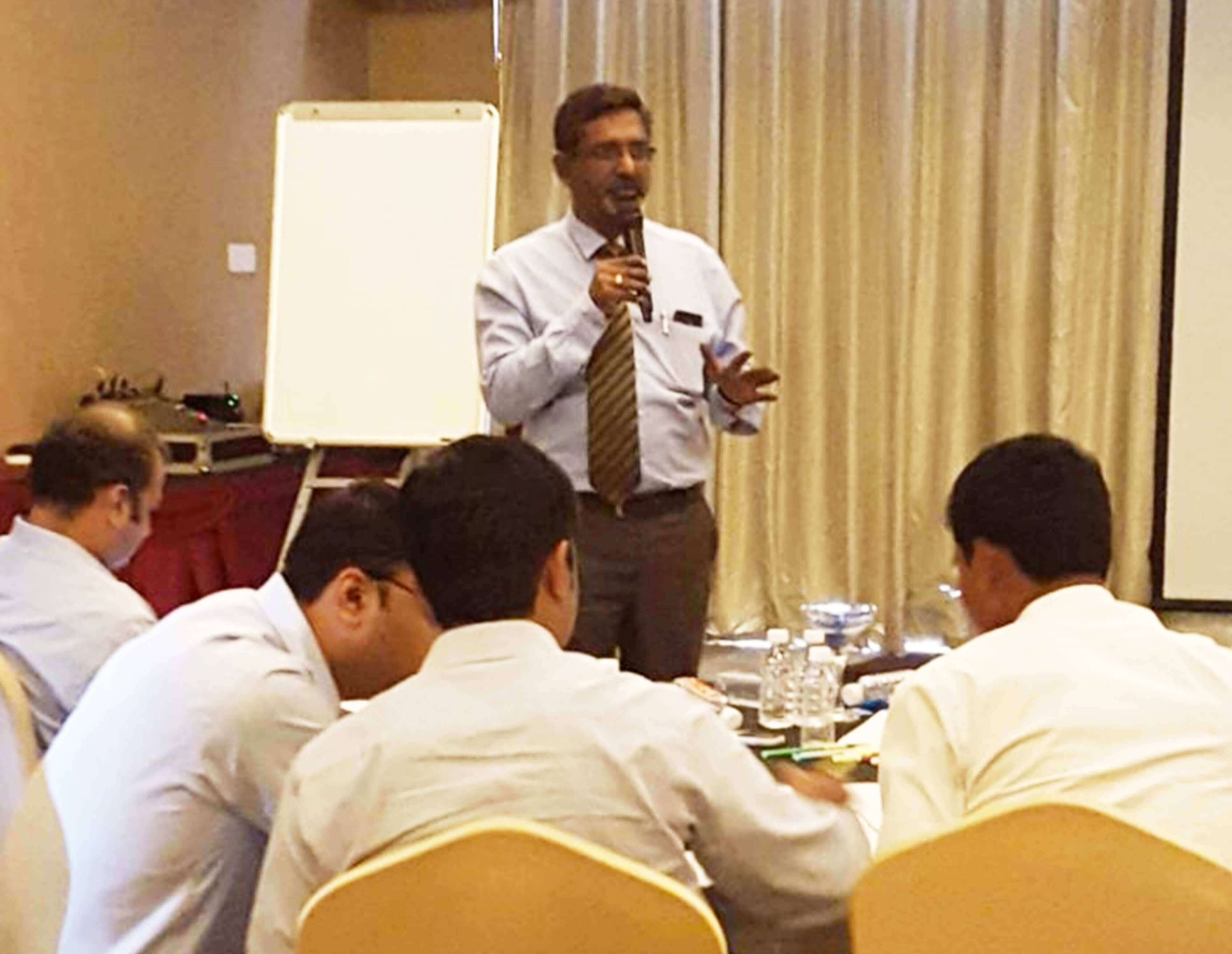 Dr. Raghu Pillai conducting a corporate training session with management participants